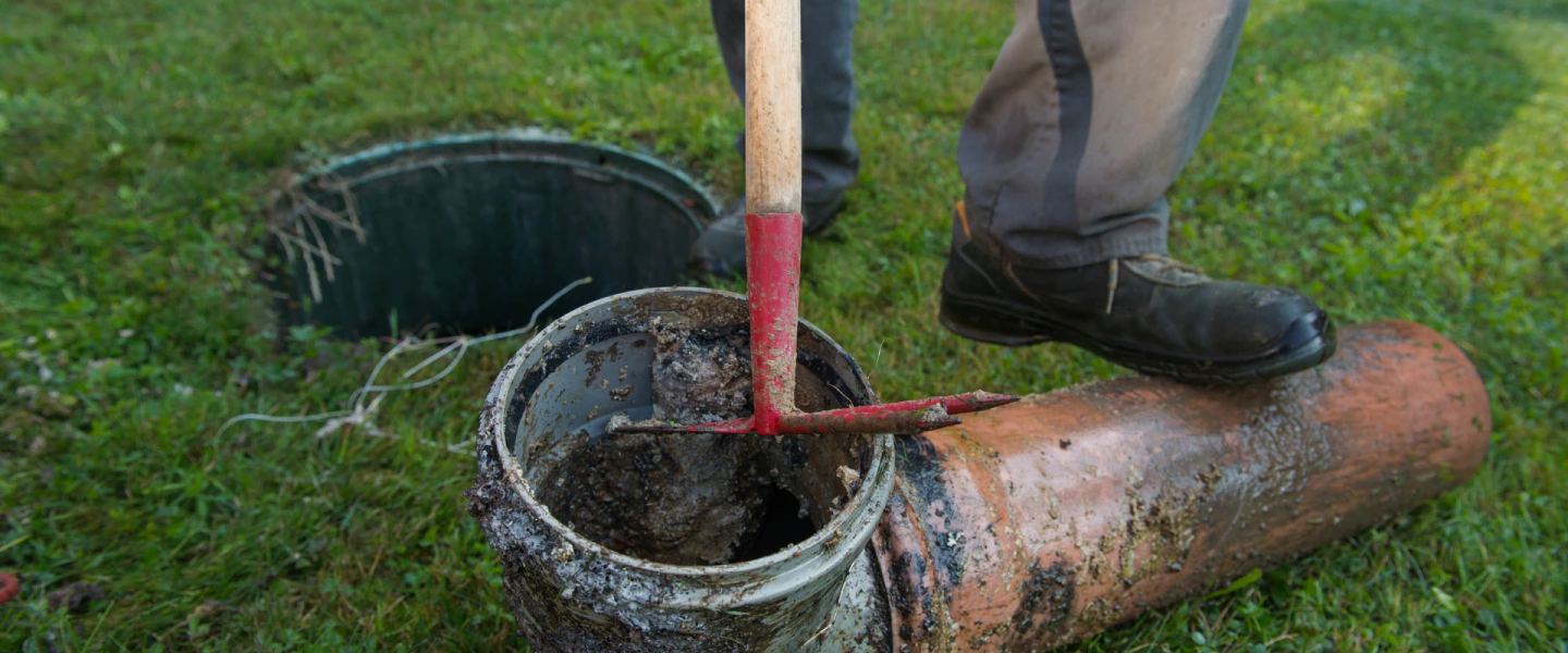 plumber inspecting broken septic pipe homeworth oh